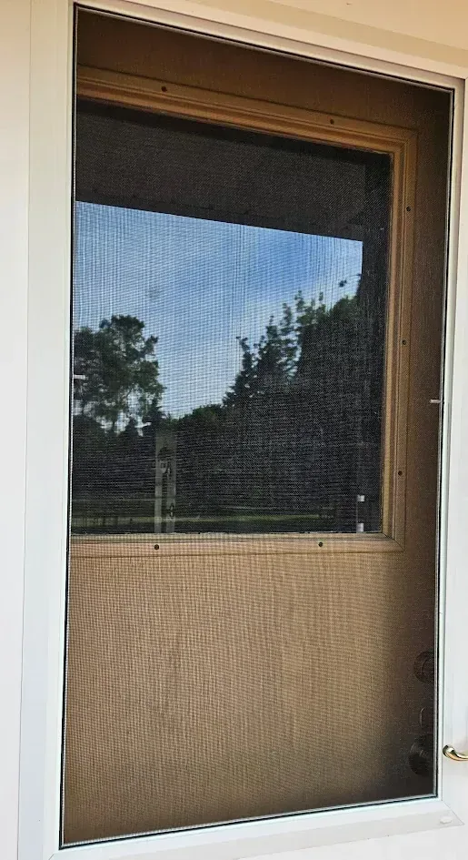 Repaired storm door screen with fresh fitted mesh