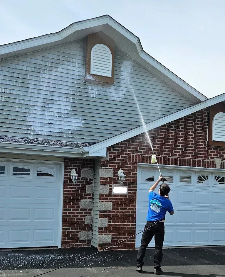 Soft washing service on a home exterior