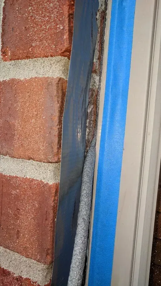 Window frame water sealing in progress, step two